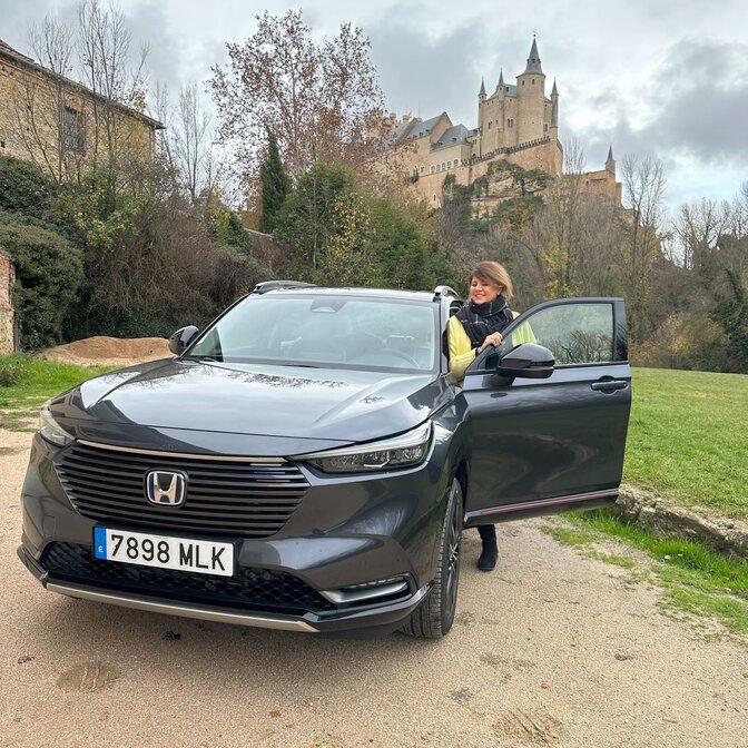 Influenceur montant dans un Honda HR-V à proximité d'un château. 