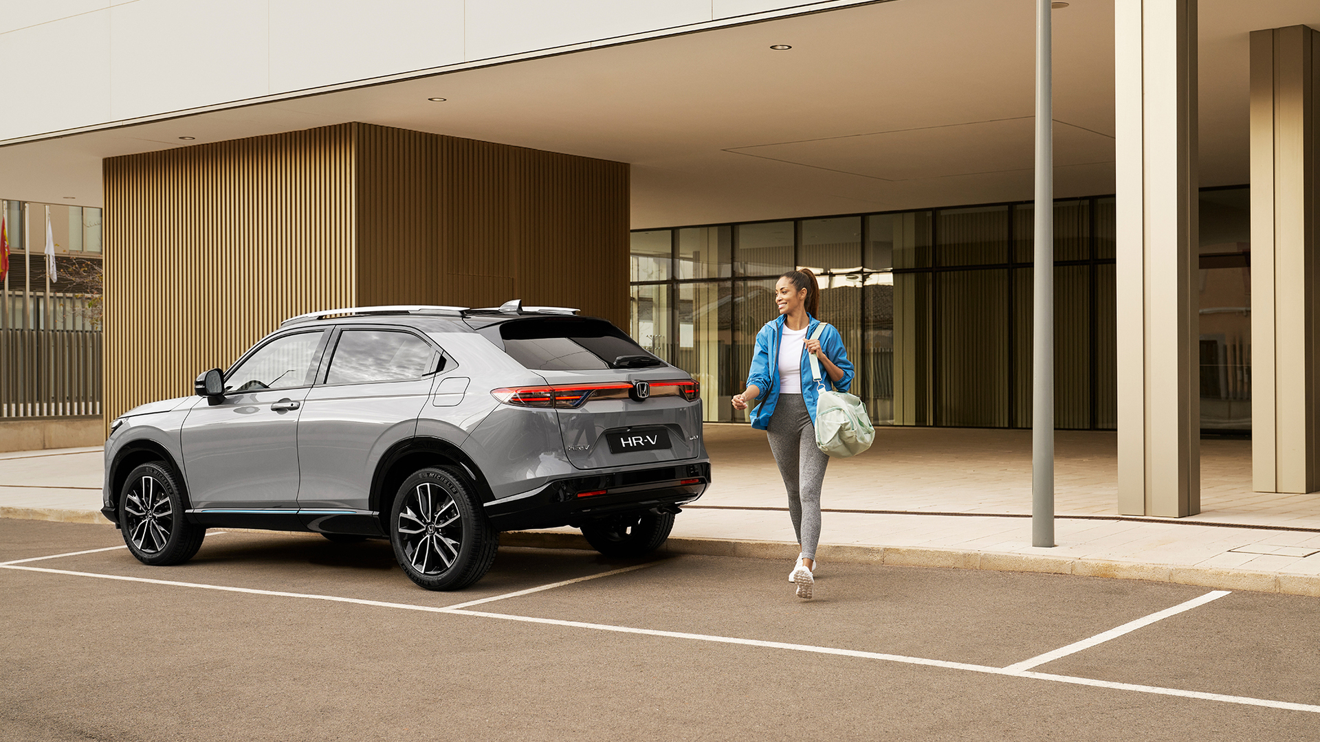 Femme passant devant un HR-V en stationnement.