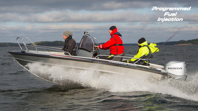 Boat using Honda engine, being used by models, coastal location.