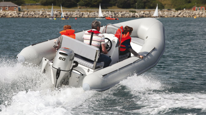Boat using Honda engine, being used by models, coastal location.