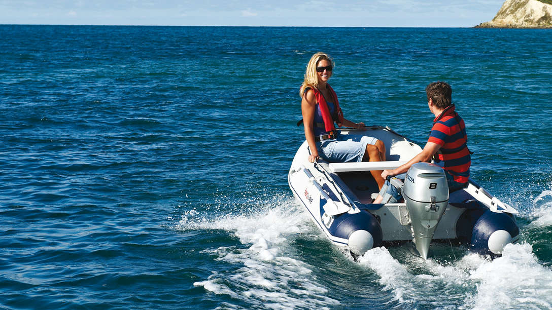 Boat with BF8 engine, being used by models, coastal location.