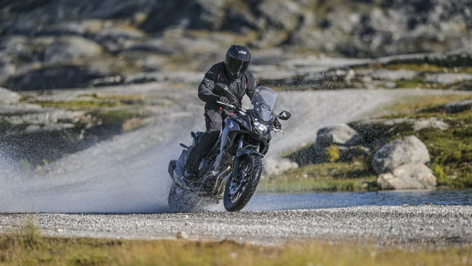 Honda CB500X riding through water.